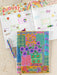 Colorful planner with floral design and text on a wooden surface