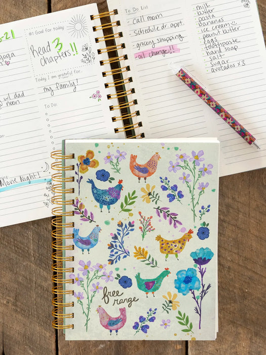 Notebook with floral and chicken design on cover, open to a page with handwritten notes.