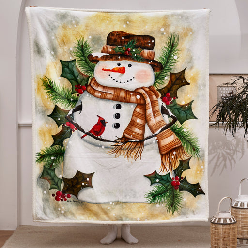Decorative blanket with a snowman design featuring a scarf, hat, and holly leaves in a room setting.