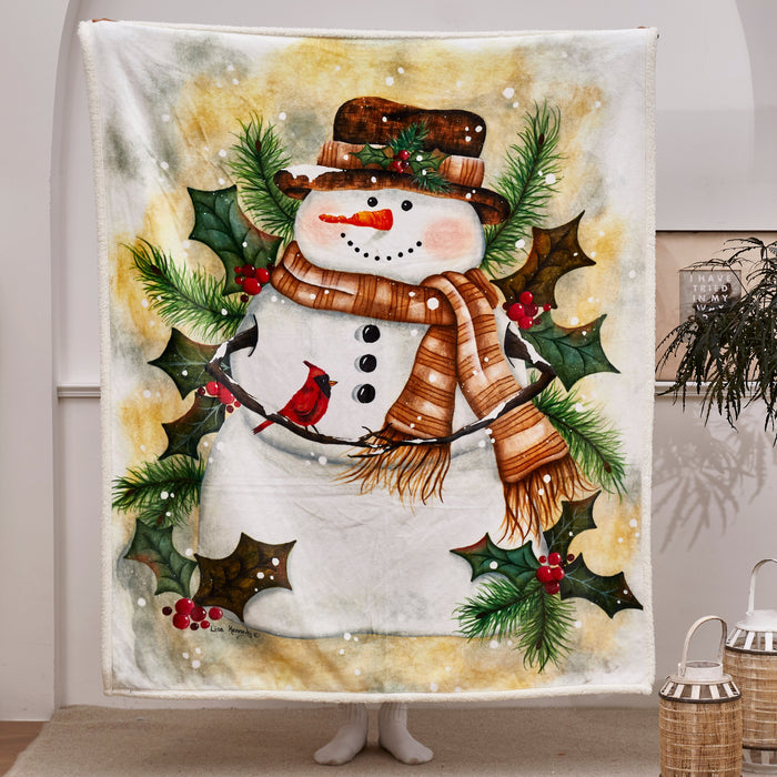 Decorative blanket with a snowman design featuring a scarf, hat, and holly leaves in a room setting.