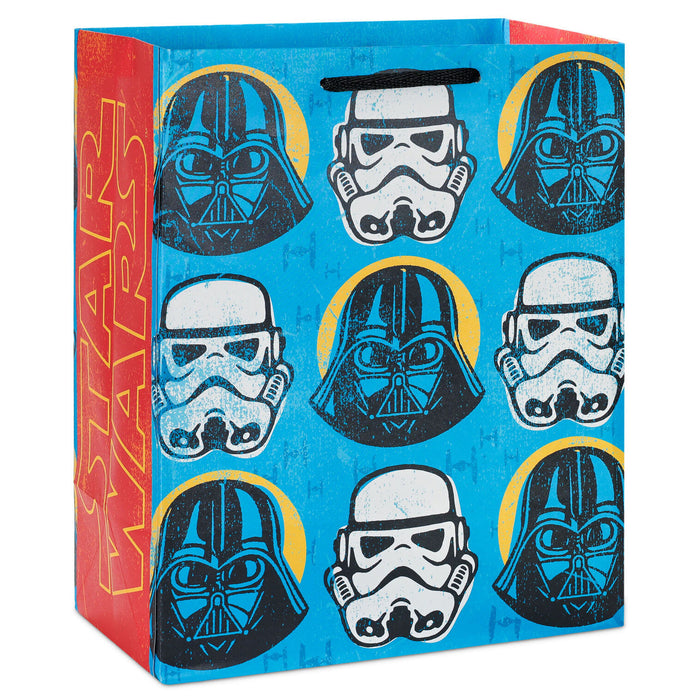 Gift bag with Star Wars-themed designs of Darth Vader and Stormtrooper helmets on a blue background.