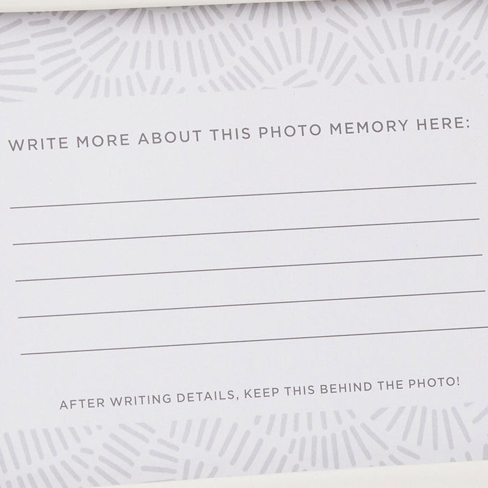 White card with text and a pattern, asking to write about a photo memory.