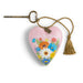 Heart-shaped keychain with floral design and tassel on a white background