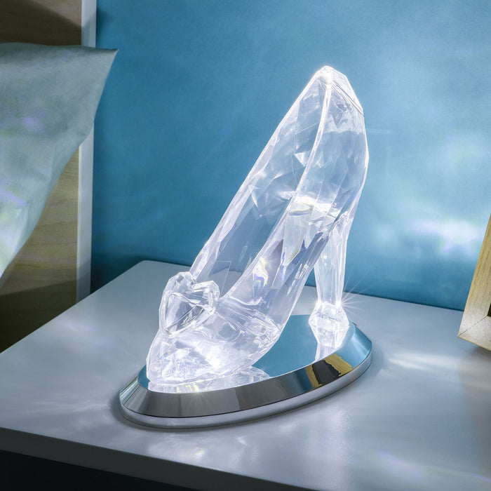 Crystal high-heeled shoe on a stand with a blue background