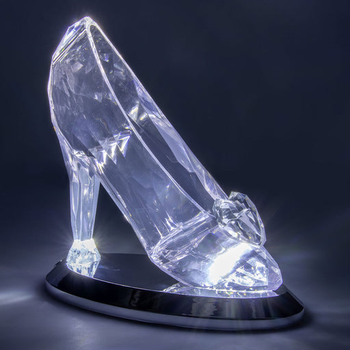 Crystal high-heeled shoe with LED lights on a dark background