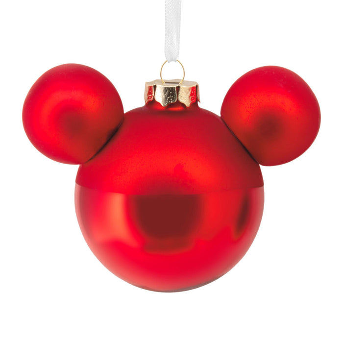 Red ornament shaped like a face with two round ears on a white background