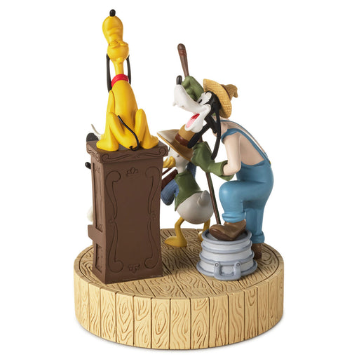 Animated character figurine on a wooden base with a white background