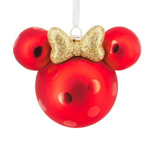 Red ornament shaped like a character's head with a gold bow on a white background