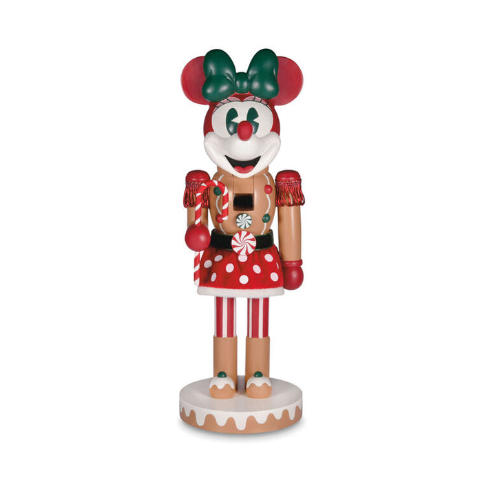 Decorative figure of a gingerbread girl with a green bow on a white background