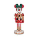 Decorative figure of a gingerbread girl with a green bow on a white background