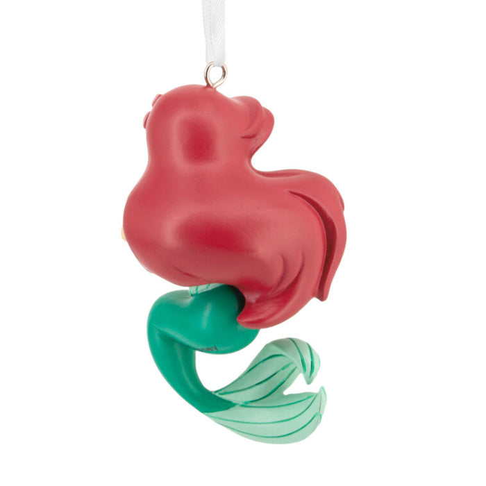 Red and green mermaid ornament on a white background
