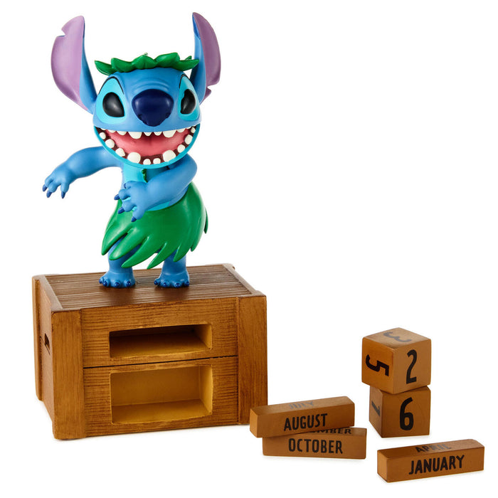 Stitch figurine on a wooden crate with wooden blocks displaying months
