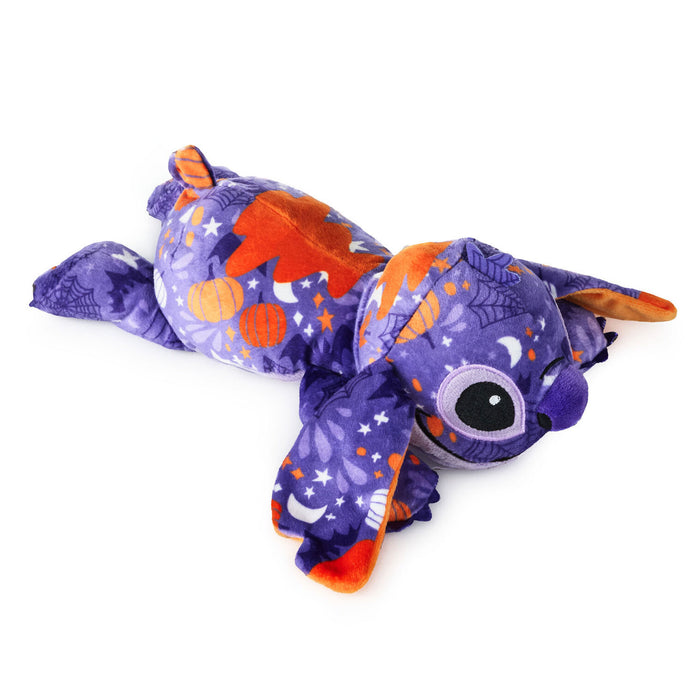 A purple plush toy shaped like a cartoon character, lying on its side against a plain white background. The fabric features an orange, purple, and white celestial pattern with stars, crescent moons, and planets.