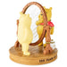 Two Winnie the Pooh figurines with a mirror on a wooden base with '100 Years of Happiness' text.