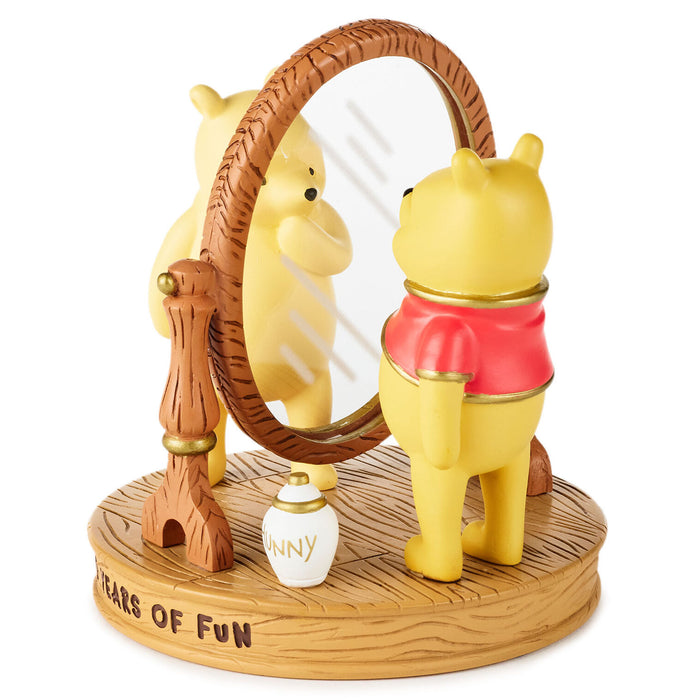 Figurine of a bear and a lion with a mirror and small bottle on a wooden base.