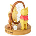 Figurine of a bear and a lion with a mirror and small bottle on a wooden base.
