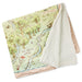 Map-themed blanket with a forest design and text on a white background