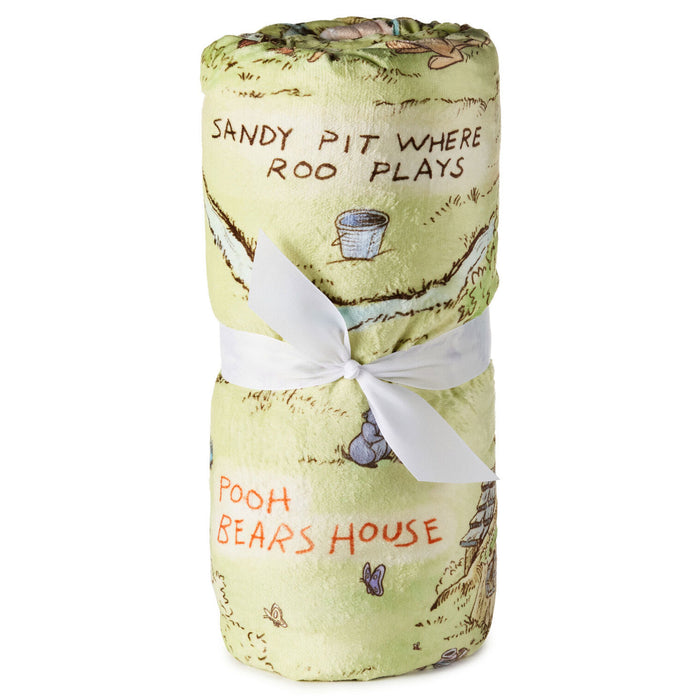 Rolled-up blanket with Winnie the Pooh design and text on a white background