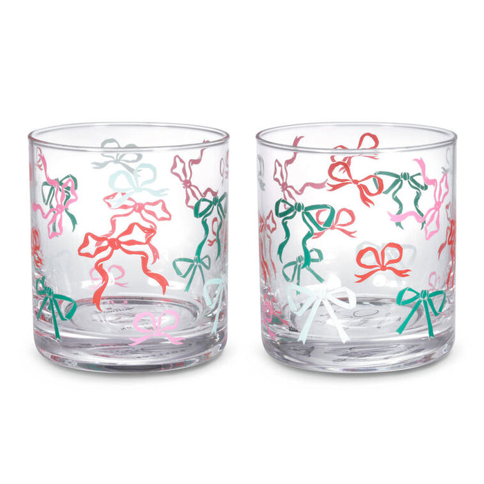 Two clear glasses with colorful bow patterns on a white background
