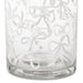 A clear glass tumbler with an etched pattern of white bows and ribbons, shown against a plain white background.
