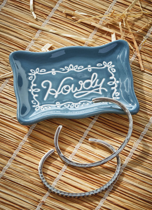Blue ceramic dish with 'Howdy' text on a straw mat