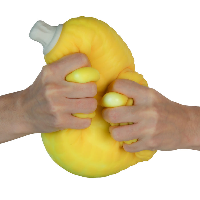 Yellow stress ball being squeezed by two hands on a white background