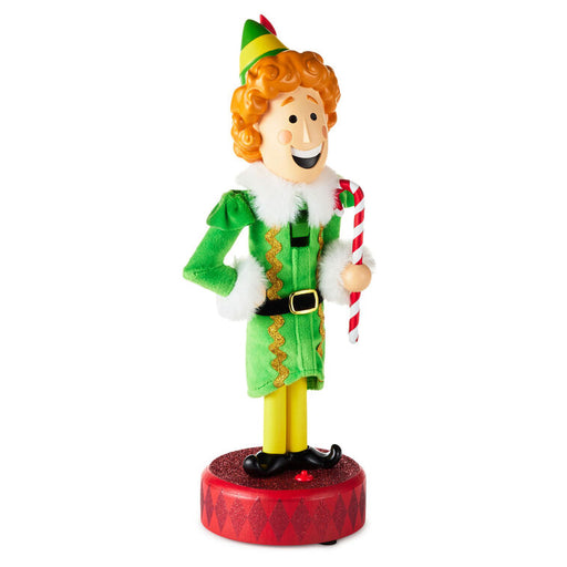Elf figurine holding a candy cane on a white background