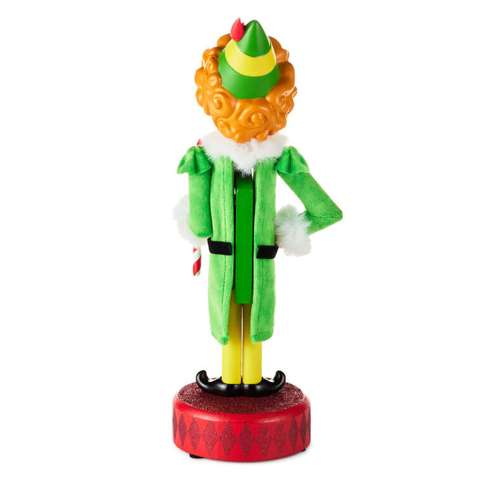 Colorful elf figurine with a green hat and coat on a white background