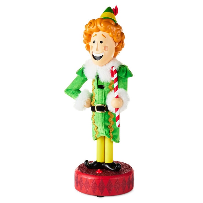Christmas elf figurine holding a candy cane on a white background