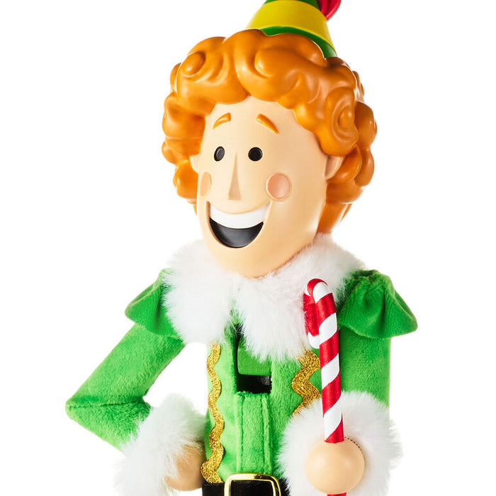 Elf figurine with a candy cane on a white background