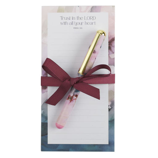 Pen with decorative bow on a card with a blue background
