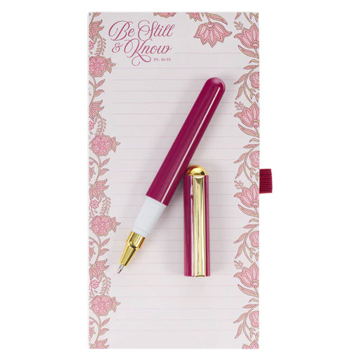 Fuchsia pen with gold accents on a floral notebook