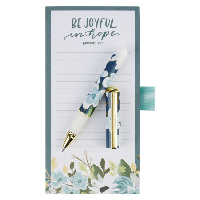 Floral pen and notepad set with motivational quote on a white background