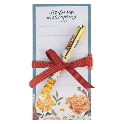Floral notepad with a pen and red ribbon on a white background