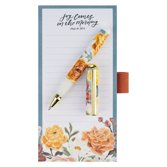 Floral pen and notepad set with motivational quote on a white background