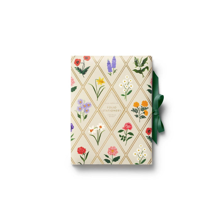 Gift box with floral design and green ribbon on a white background