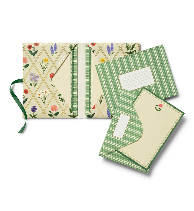 Set of stationery items with floral and geometric designs on a white background