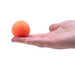 Orange ball held in a hand on a white background