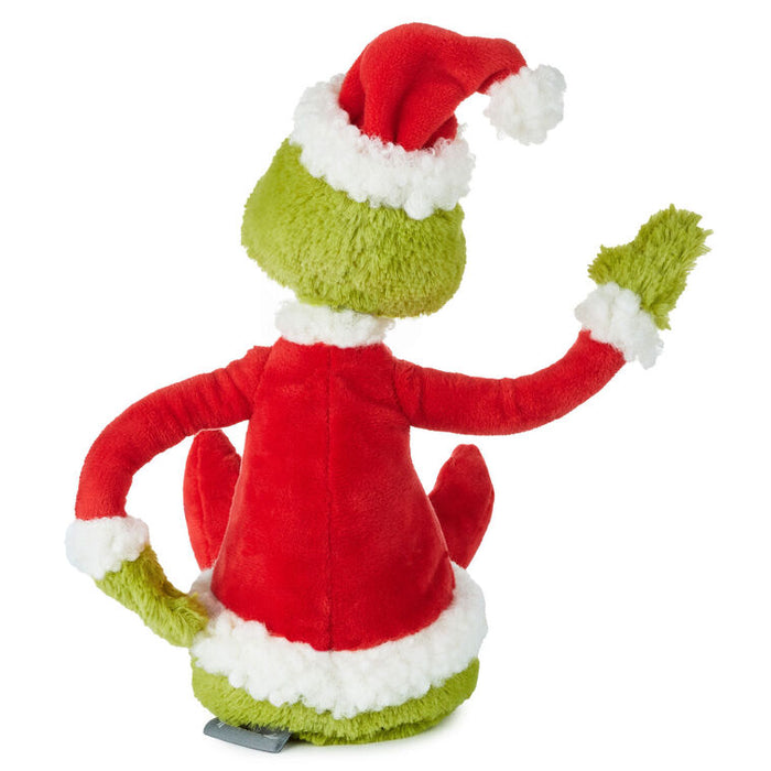 Plush toy resembling a character in a red outfit and green hat on a white background