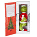 Plush Grinch toy in a box with a Christmas tree illustration on the cover