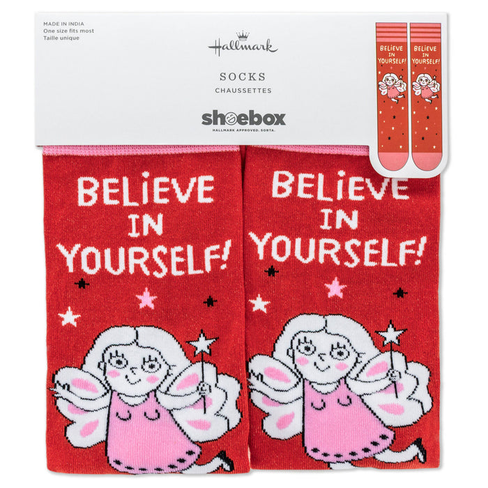Red socks with angel design and 'Believe in Yourself!' text, packaging displayed.