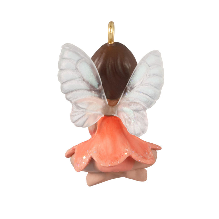 Butterfly-shaped ornament with a gold chain on a white background