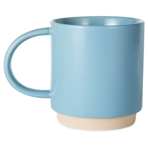 Blue mug with a beige base on a white background