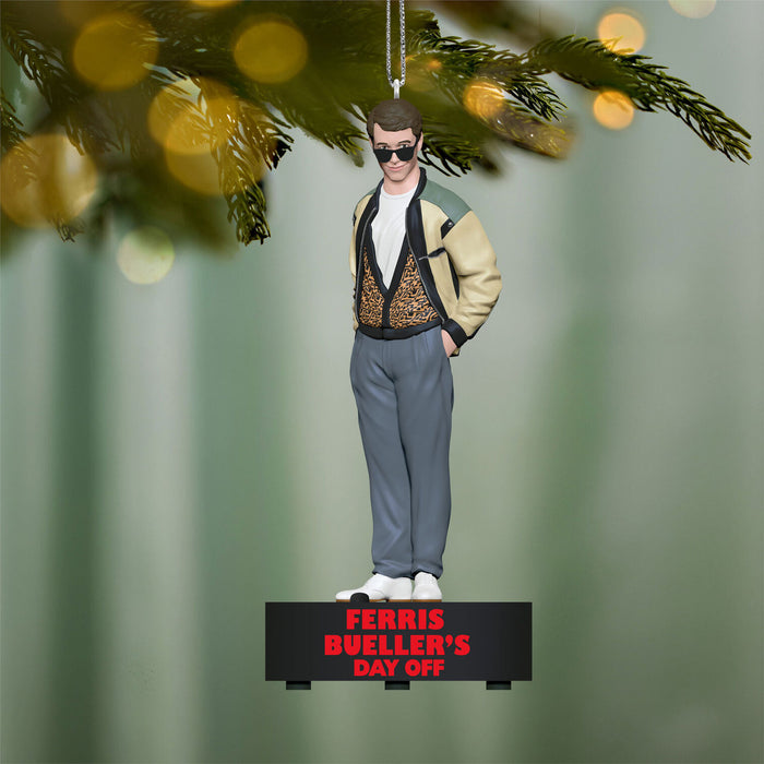 Ferris Bueller Christmas ornament hanging on a tree with a blurred green background