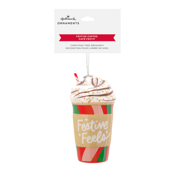 Hallmark Christmas ornament shaped like a festive coffee cup with whipped cream on a white background.