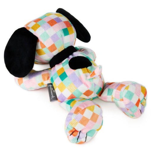 Colorful checkered dog plush toy on a white background