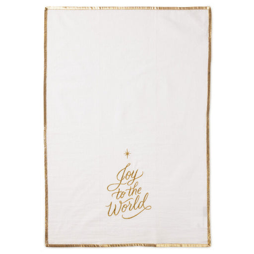 White blanket with gold 'Joy to the World' text and star design on a white background