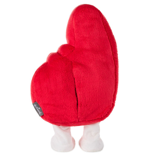 Red plush heart-shaped toy with white feet on a white background
