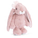 Plush toy rabbit with pink fur on a white background
