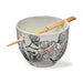Ceramic bowl with floral design and chopsticks on a white background